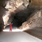 A caver standing on Fort Stanton Cave's Snowy River.