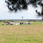 Police gather outside Tank cave on Sunday afternoon