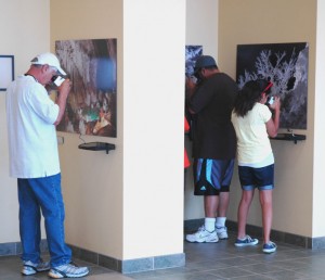Visitors at Carlsbad Caverns National Park examine 3D photographs of Lechuguilla Cave