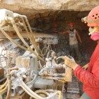 Cavers Rand Heazlitt and Ryan Cox drilling in the tunnel, which will soon open into Big Bone Mountain room of Indiana Caverns