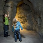 Children enjoying the cave in the Vale Earth Gallery.