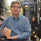 Professor Truman Simanjuntak holding an exact replica of an ancient stone hand axe excavated from East Java.