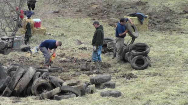 Using sawzalls to cut the tires open so the clay inside could be removed.