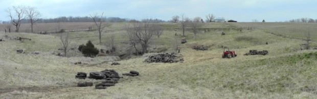 Panorama of the field filled with piles of tires.