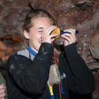 Jewel Cave National Monument employee Rene Ohms helps Custer Student Tori Dahlstrom read a clinometer in Wind Cave.