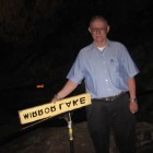 Former National Park Service park guide Tom Lorig with the Mirror Lake sign.