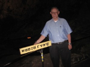 Former National Park Service park guide Tom Lorig with the Mirror Lake sign.