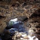 Sunlight filters into Lava Beds National Monument's Blue Grotto Cave.