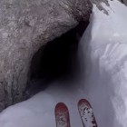 Extreme skier Candide Thovex entering a small cave.