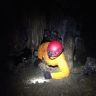 A caver in the Big Squeeze in Virginia's Bowling Cave.