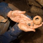 Agate stones that were part of a string of beads and the Hellenistic oil lamp in which the stones were kept.
