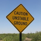 Sign warns of unstable ground.