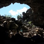 A young explorer exiting Skull Cave at Lava Beds National Monument.