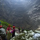 Workers clean up a 290 meter (950 foot) deep sinkhole in China.