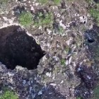 A cave entrance as seen from a drone.