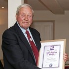 Chris Baker, left, receives a specially-produced certificate from National Mountain Rescue England and Wales president Peter Bell
